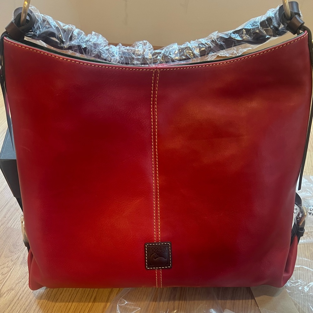 Dooney And Bourke Red Leather Medium Sac Hobo Shoulder Bag with twisted strap.
